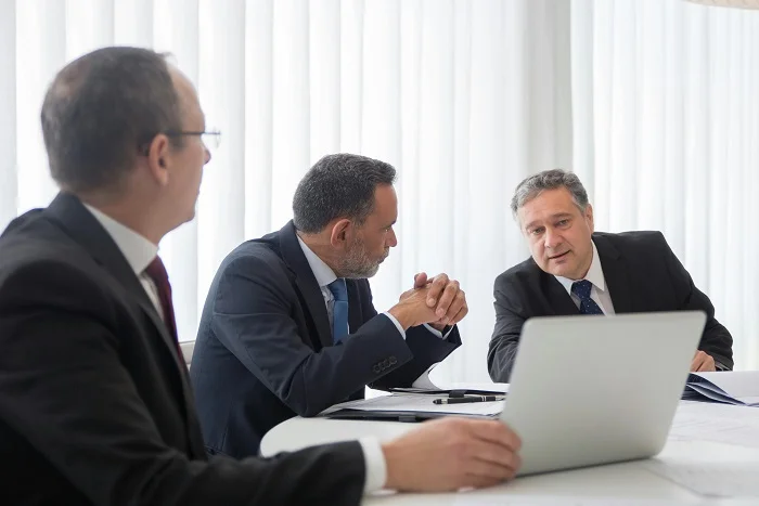 Executives discussing acquisition strategy in a business meeting