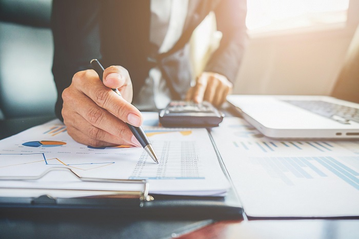 Reviewing financial documents and calculations during due diligence and closing