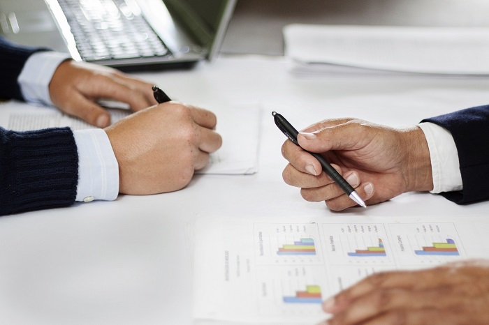 Advisors reviewing strategic plans and performance reports with a client