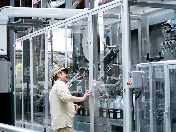 Worker operating industrial manufacturing equipment
